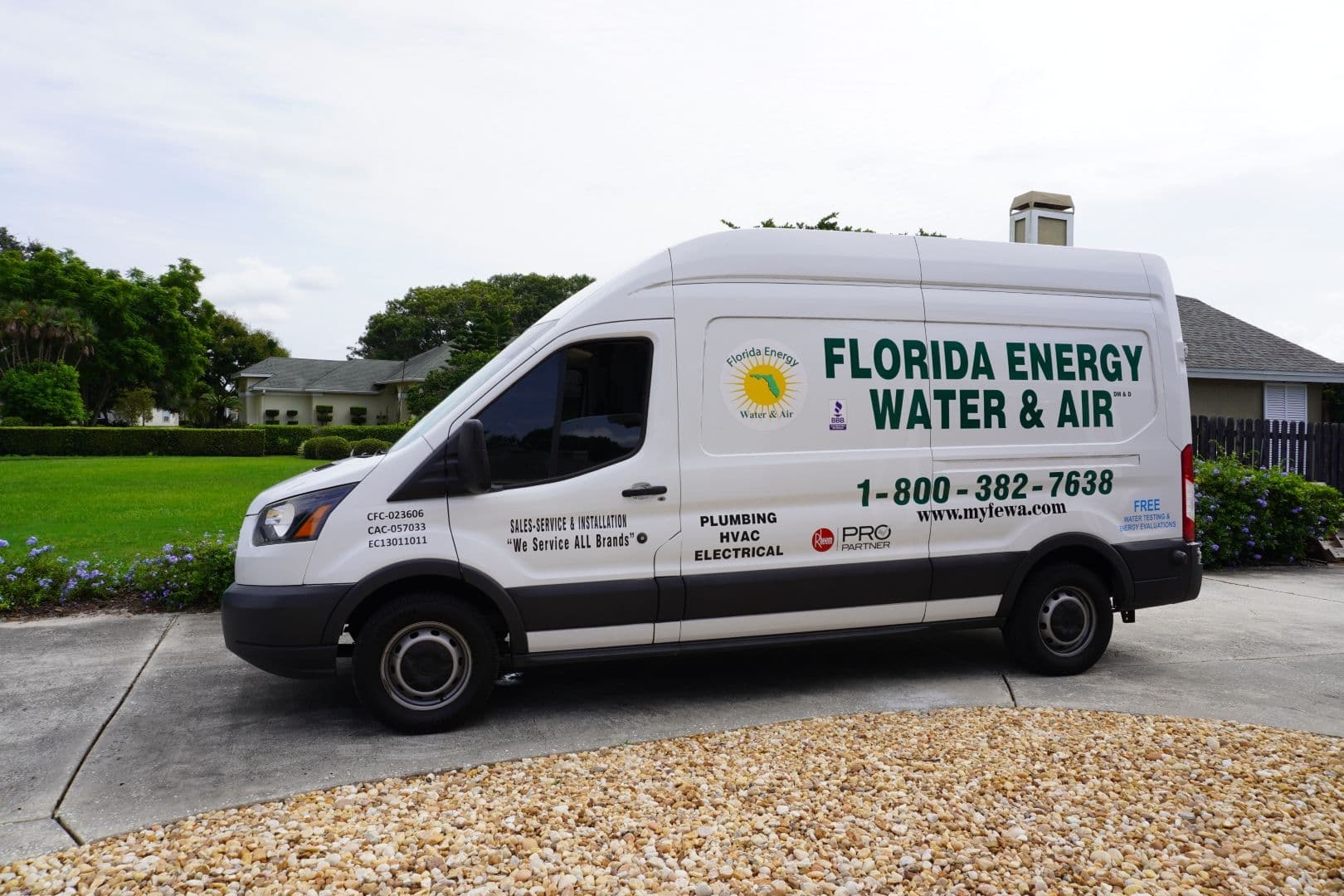 A Florida Water Energy and Air (FEWA) truck parked in a driveway.