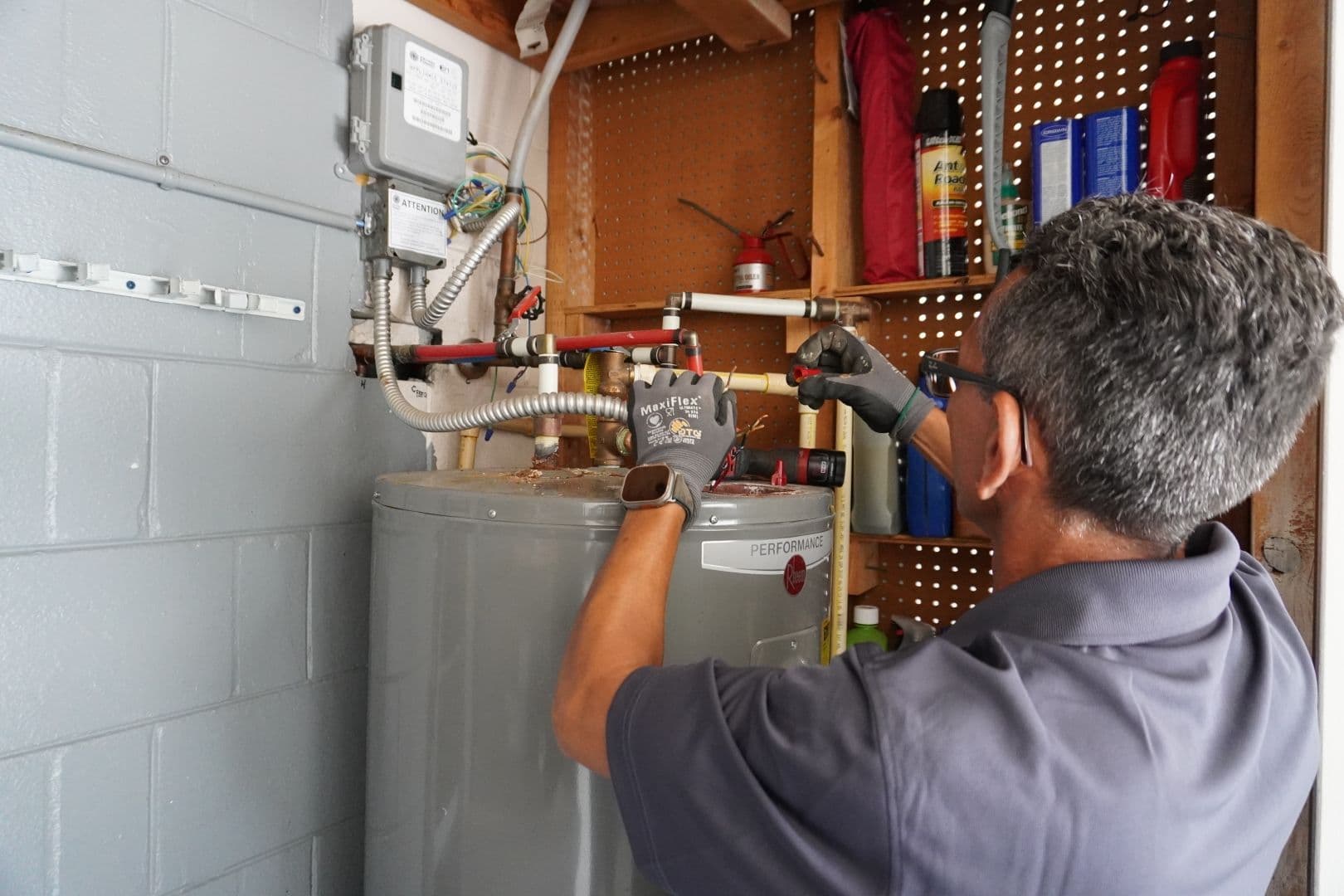 A FEWA employee installs a water heater.