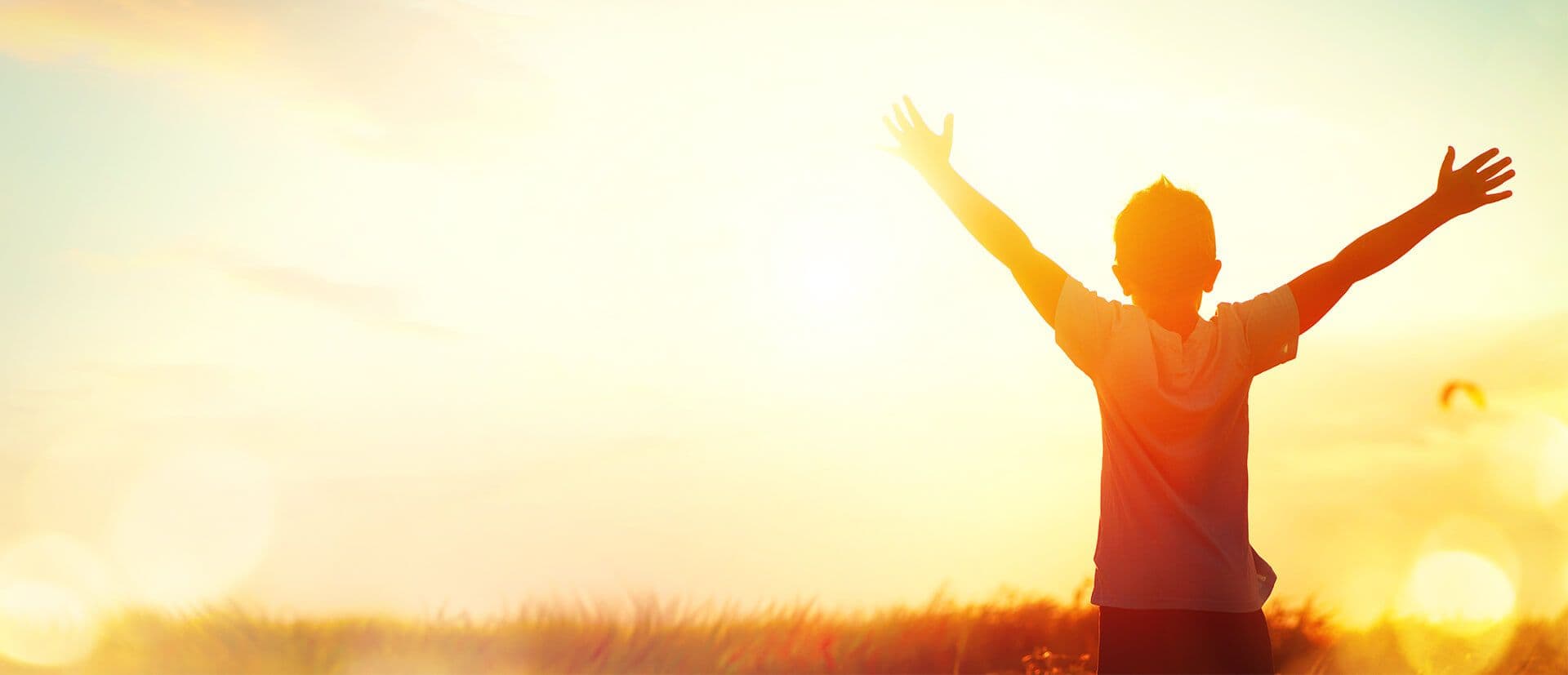 The silhouette of a person on a sunny horizon.