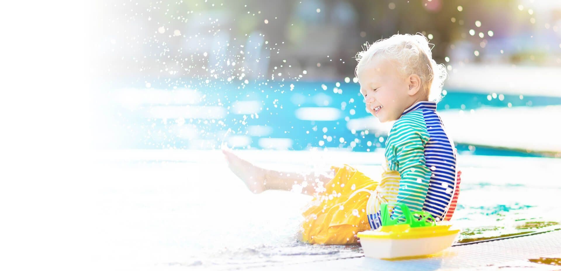 A child splashes in a pool.