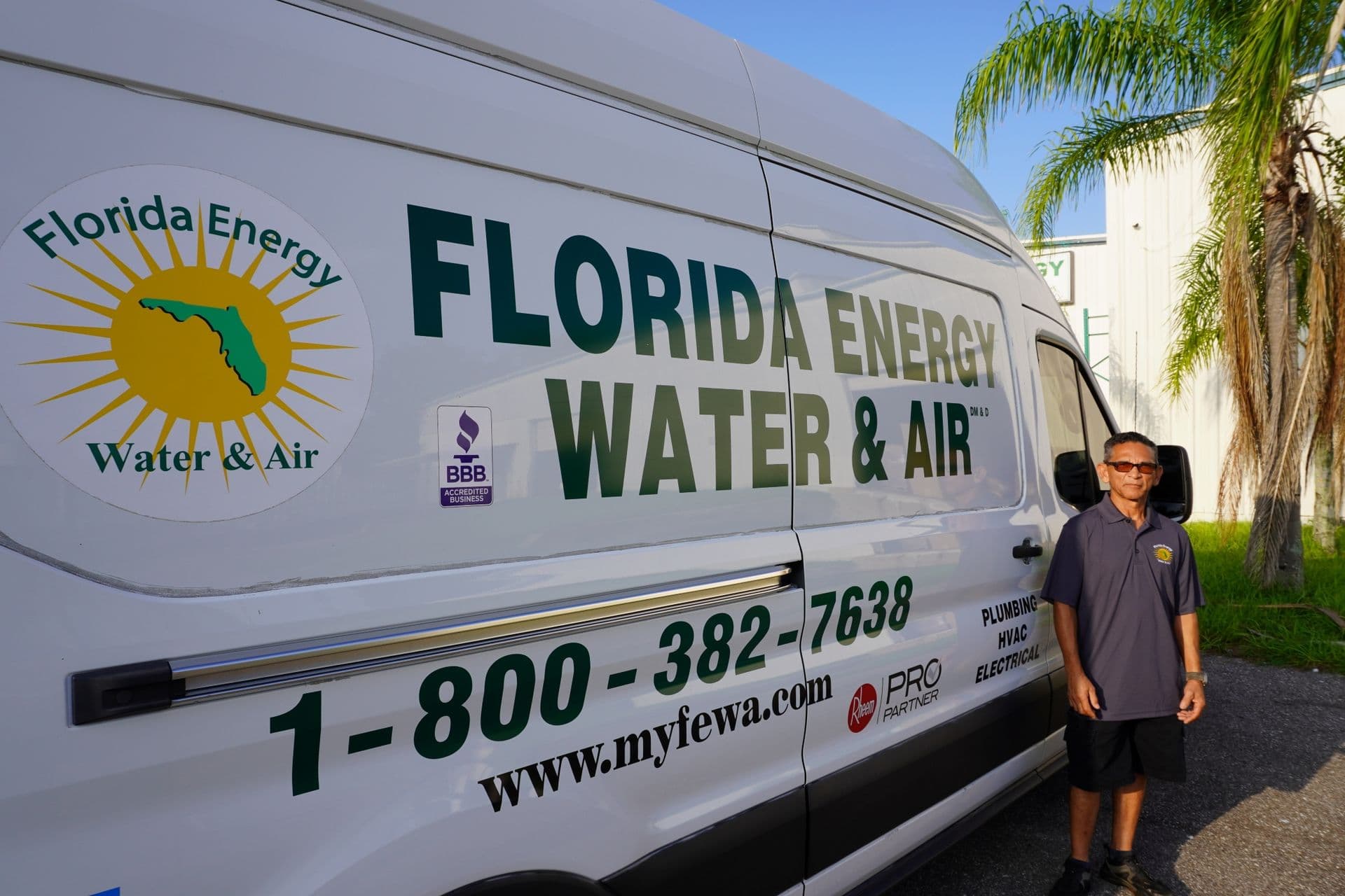 A FEWA employee stands beside a Florida Energy Water & Air truck.